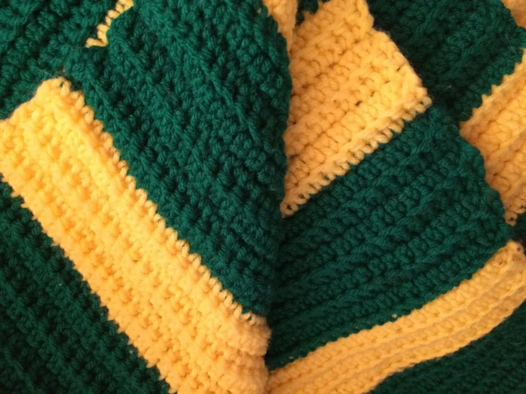 close up of greed and gold afghan