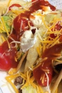 Beef Tacos with filling, sauce, and sour cream