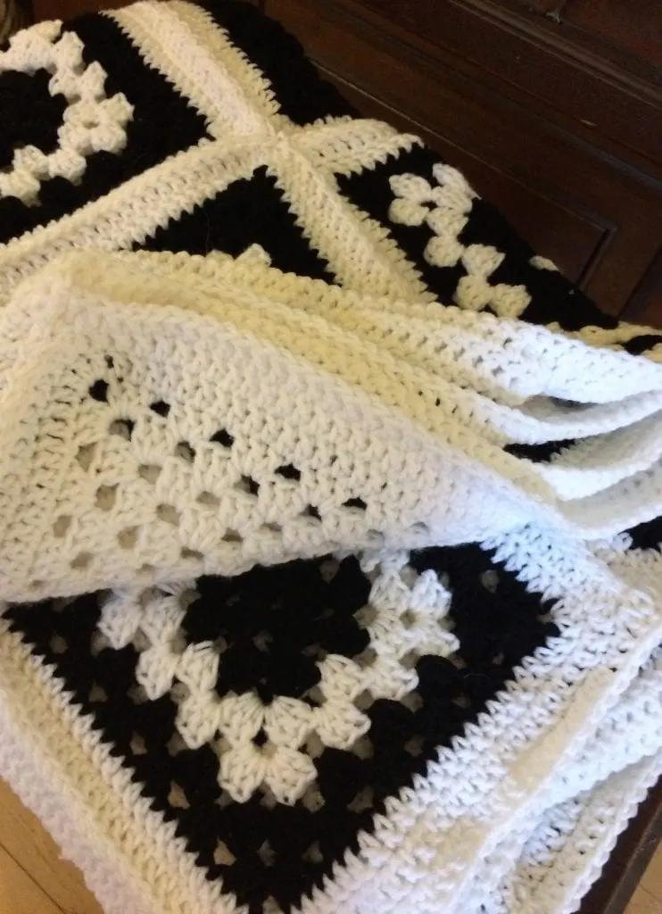Finished black and white granny square afghan