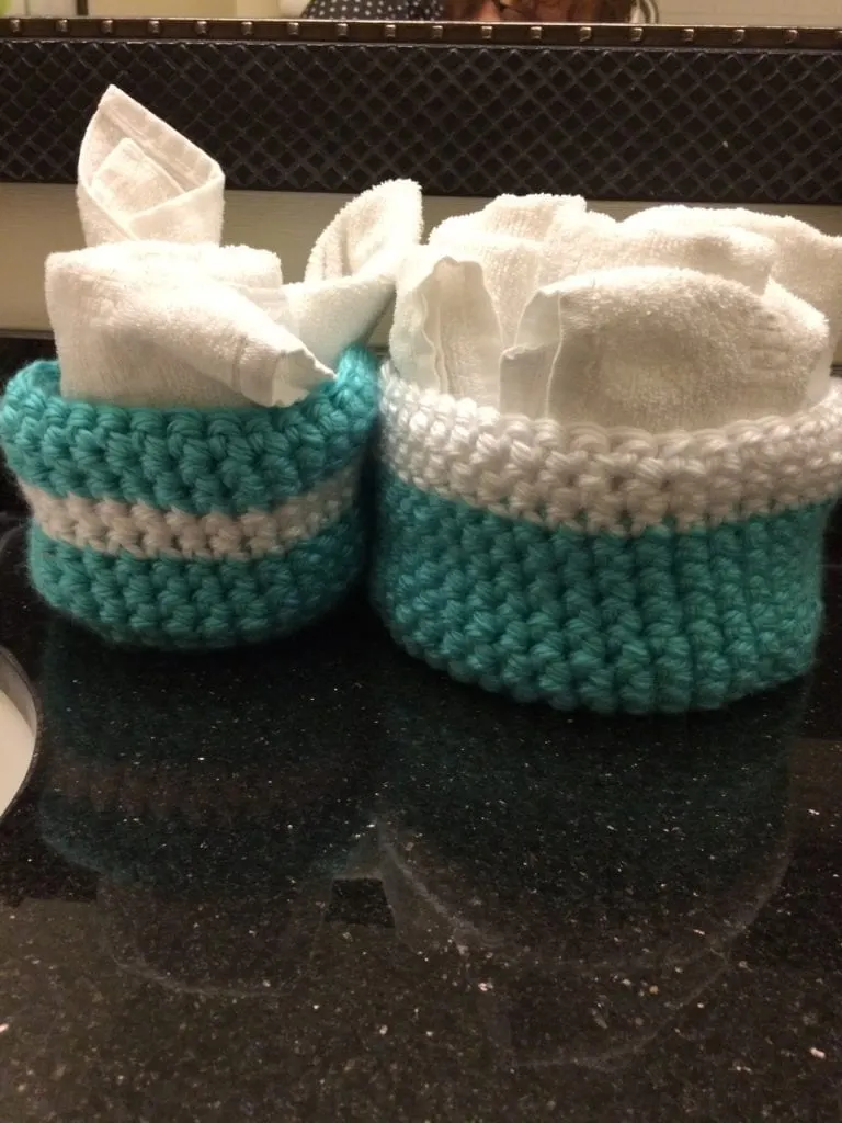crochet baskets holding towels