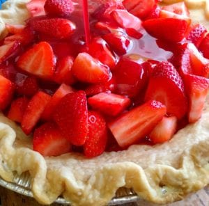 Adding strawberry gelatin to the pie