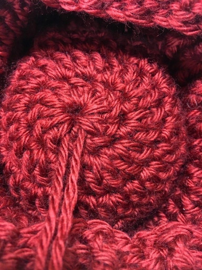 Pull yarn pieces through the hat