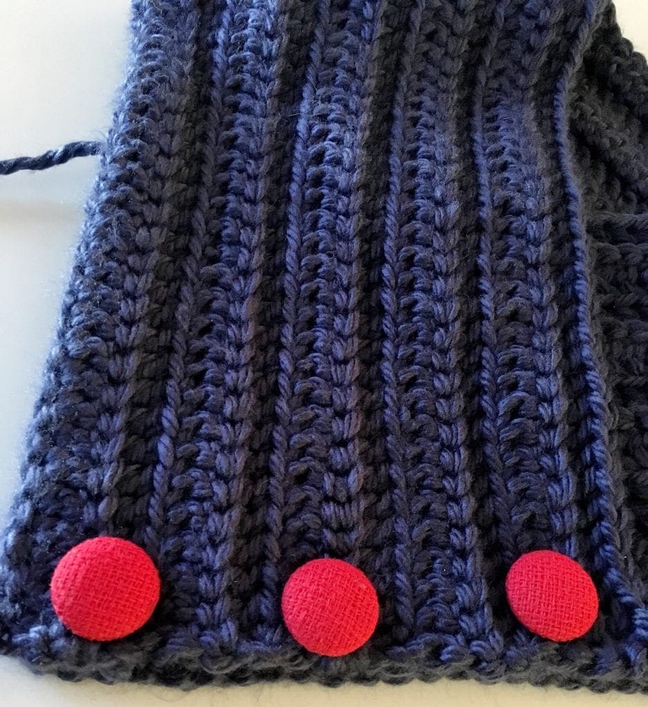 Sewing Red Buttons on Neck Warmer