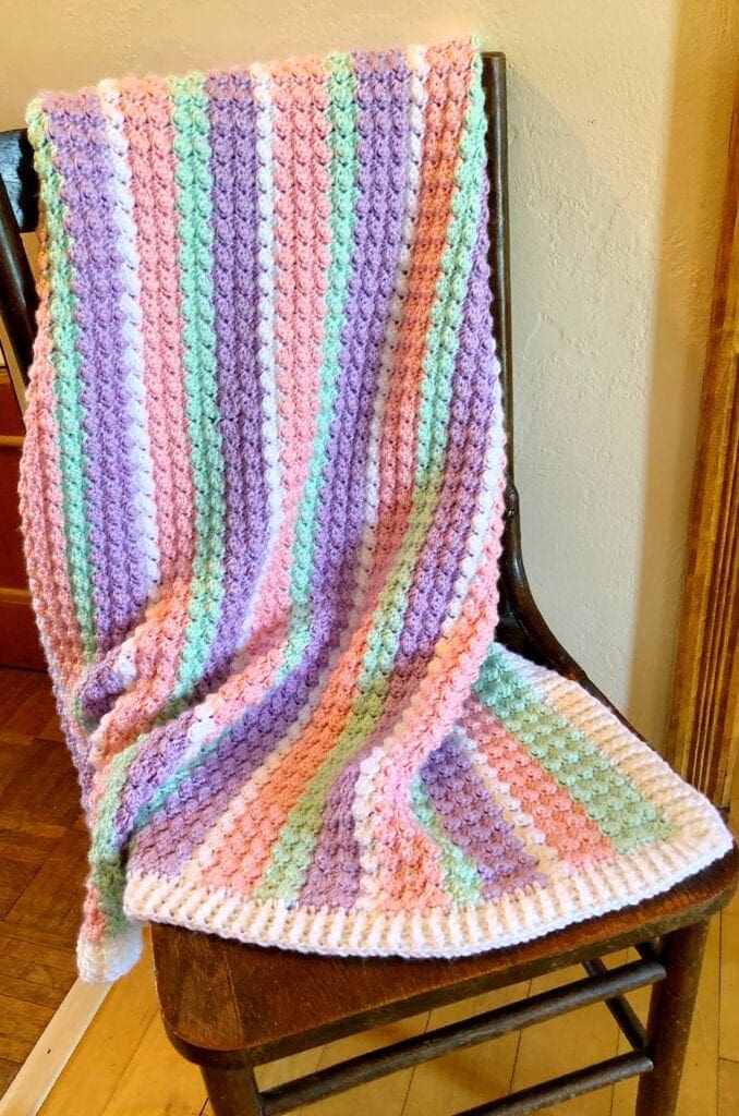 Baby Blanket with White Border on Chair