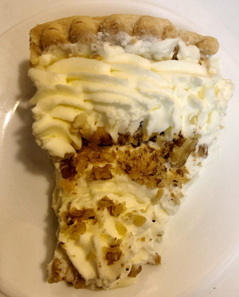 Banana Cream Pie with Whipping Cream and Chopped Pecans