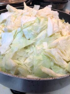 Adding Shredded Cabbage to Skillet