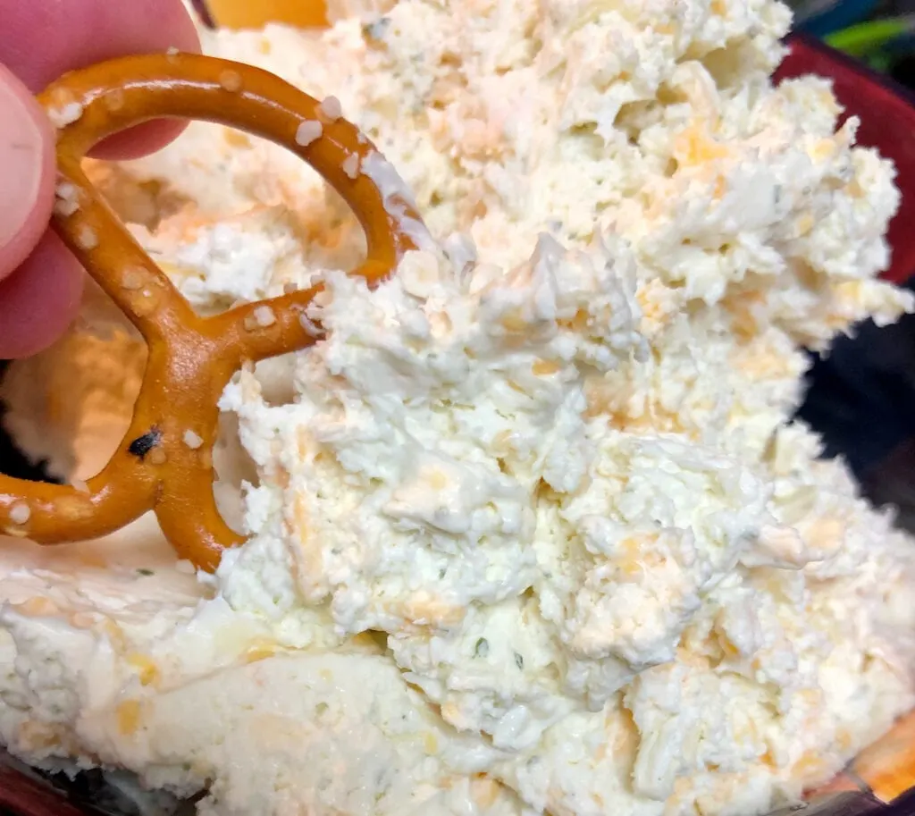 Scooping Cheese Dip with a Pretzel