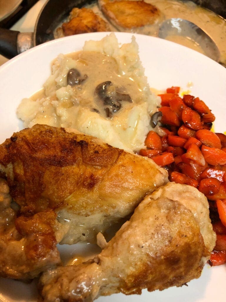 Family Meal with chicken, mashed potatoes, gravy , and carrots