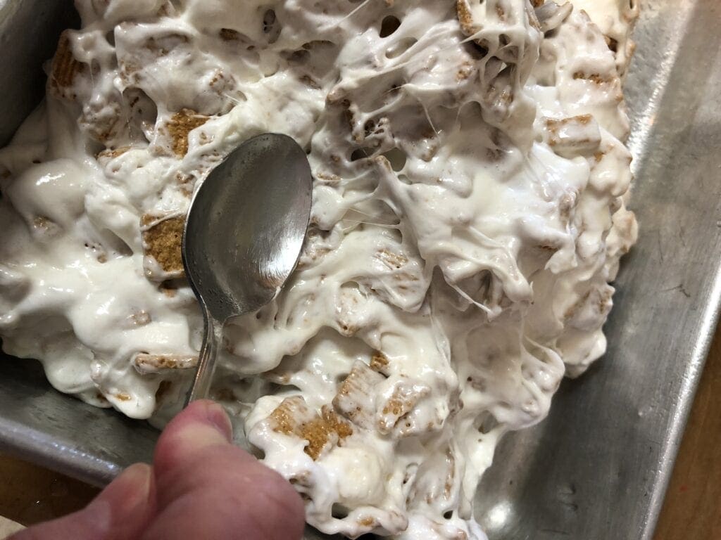 Spreading Golden Graham Treats in the Pan