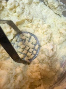 Mashing the Potatoes and Cauliflower with a Hand-Held Masher