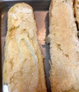 Adding Butter and Garlic Powder to a French Brioche Baguette