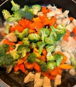 Adding Broccoli to Vegetables and Chicken Skillet