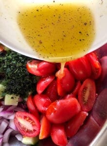 Adding Salad Dressing to the Tomato and Cucumber Mixture