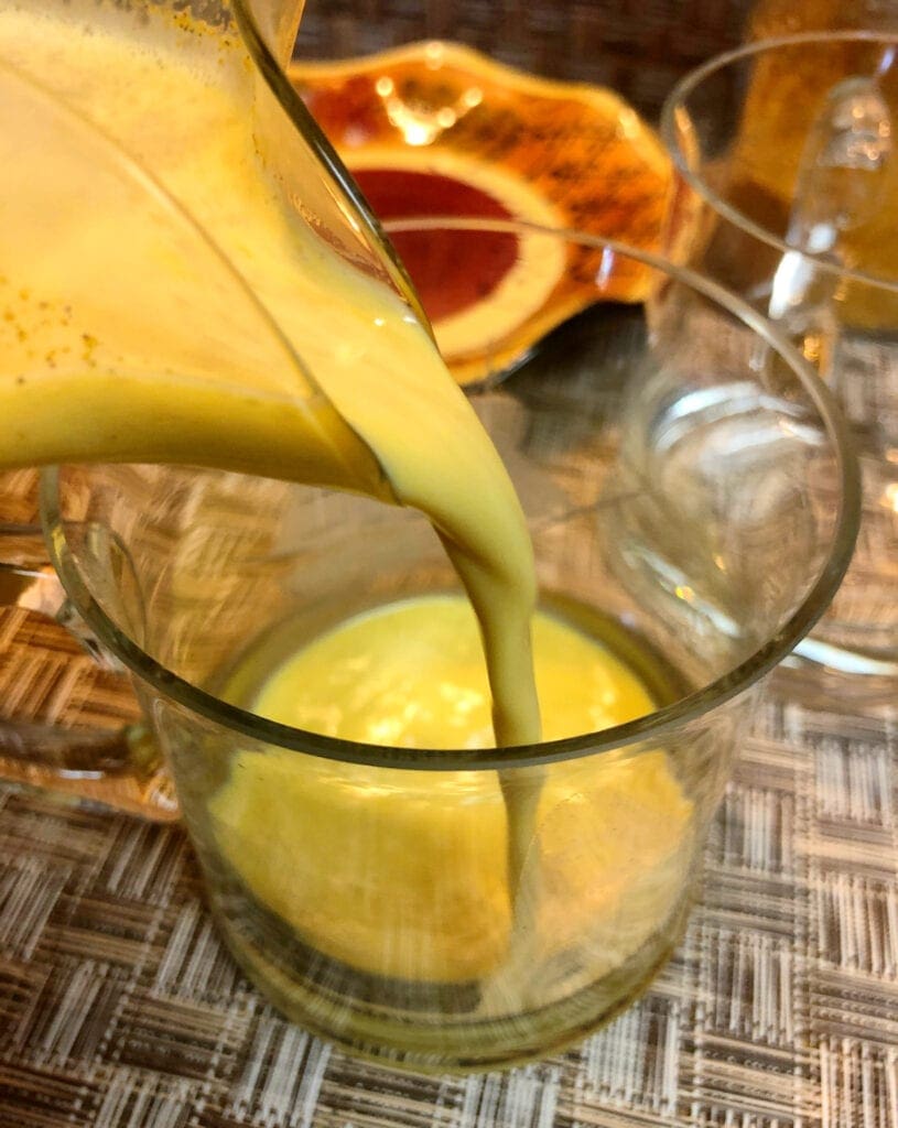 Pouring Turmeric Golden Milk Drink