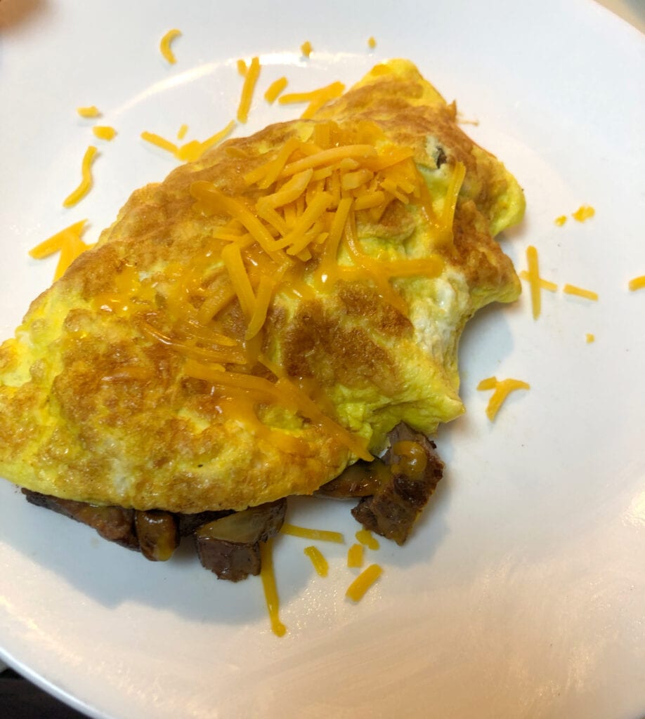 Easy Steak Mushroom and Cheese Egg Omelette Topped with Shredded Cheese