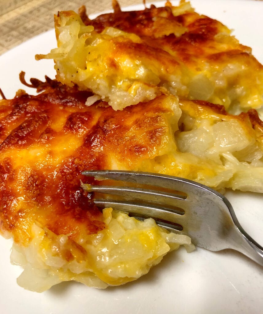 Restaurant-Style Hash Brown Casserole Being Eaten with a Fork