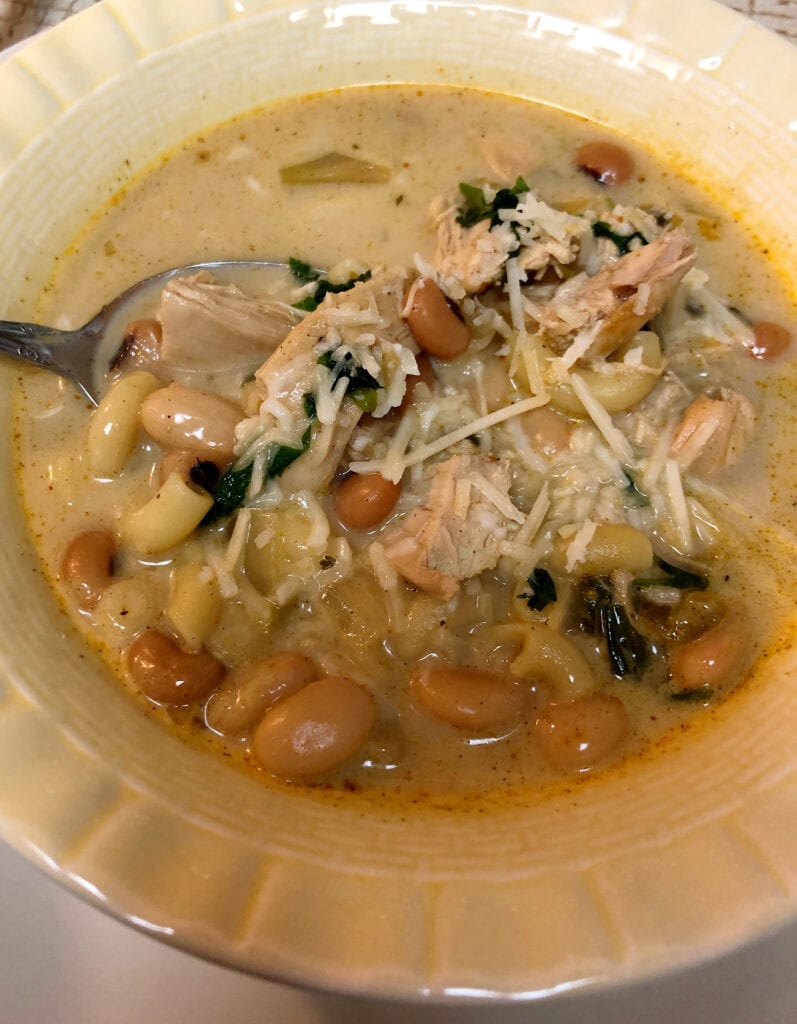 Enjoying Chicken Chili in Soup Bowl with Shredded Parmesan