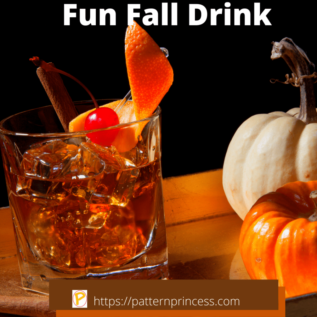 Fun Fall Bourbon Drink Garnished with Orange Rind Cherry and Cinnamon Stick