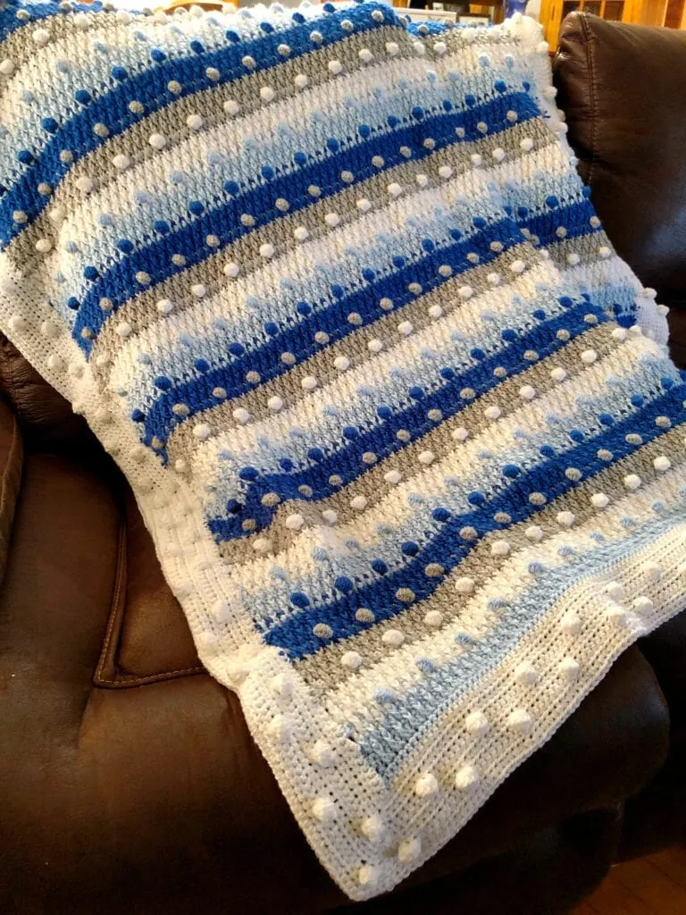 Crochet Blue, White, Silver Christmas Blanket on Sofa