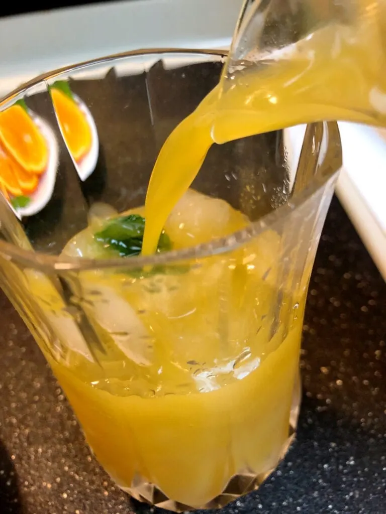 Pouring Orange Juice Drink in a Glass