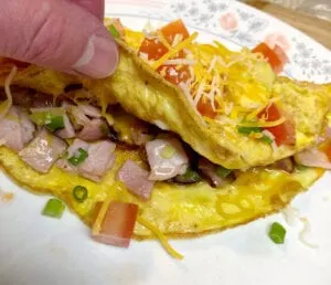 Lifting the Omelet to Show the Scrumptious Fillings