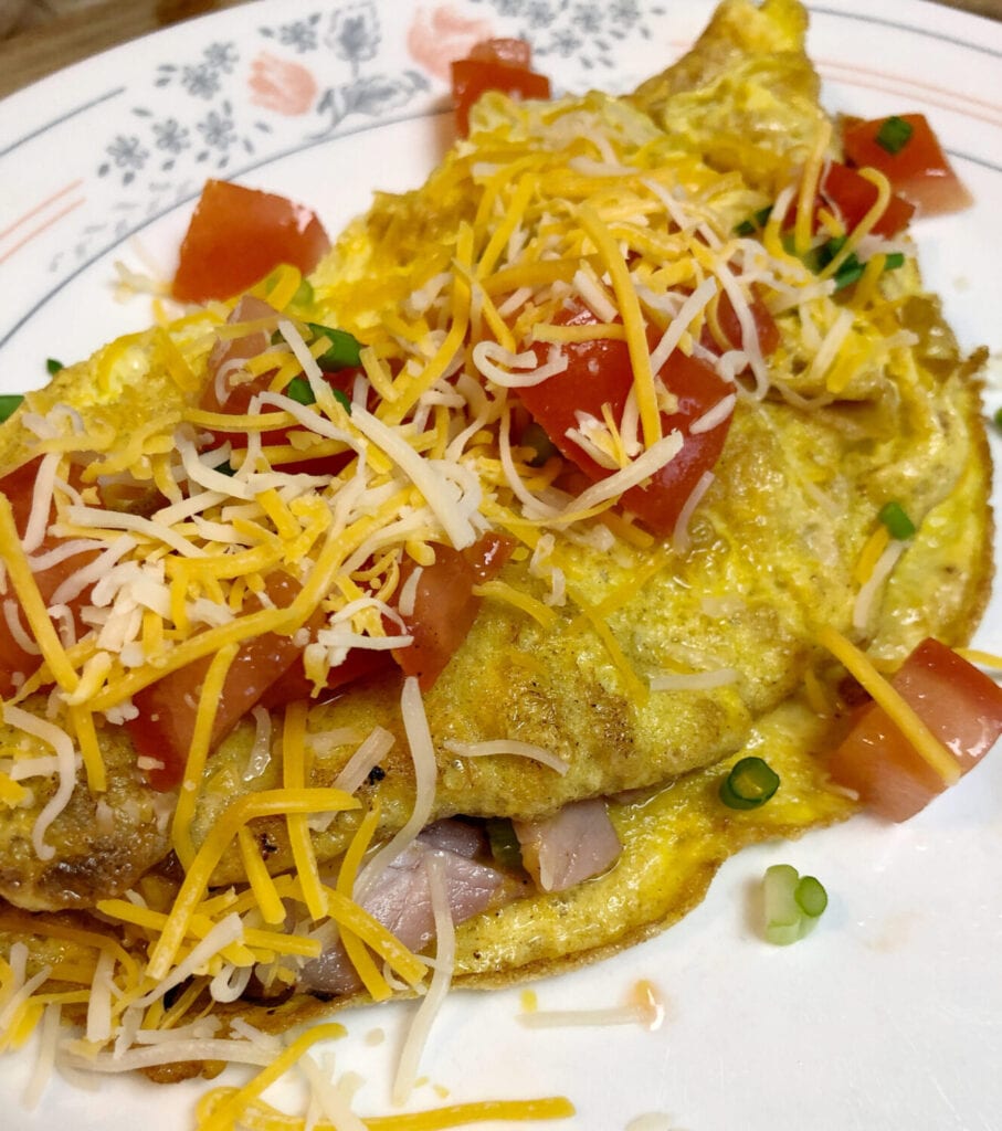 Smoked Ham Omelet with Shredded Cheese Green Onions and Tomatoes
