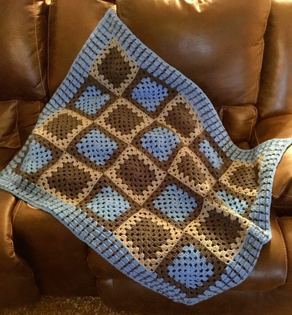 Bright Blue and Grey Baby Blanket displayed on chair