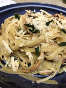Linguine Noodles in Serving Bowl Topped with Parsley and Shredded Cheese