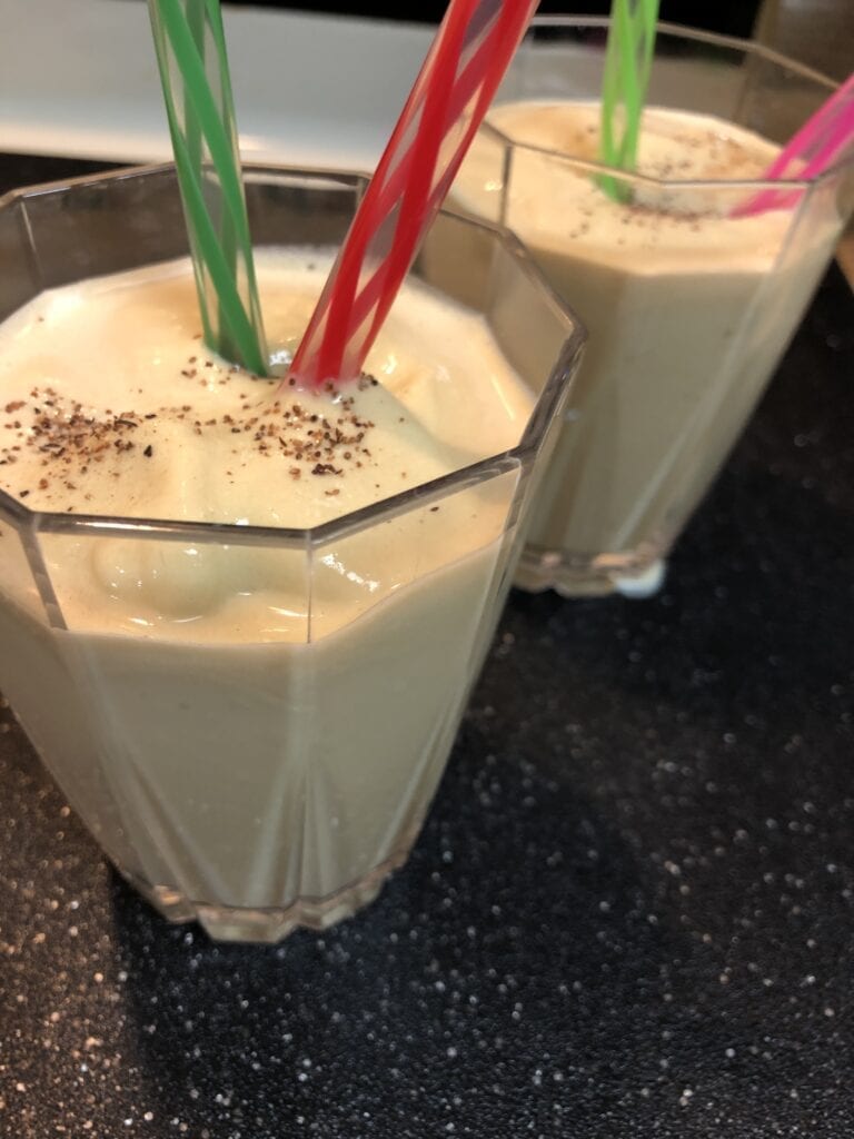Two Glasses of After Dinner Drink Topped with Nutmeg