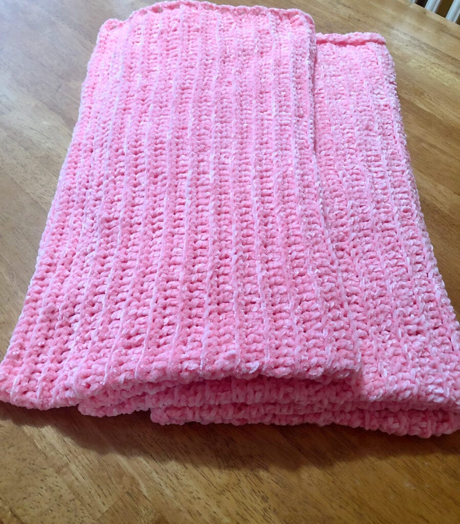 Pink Velvet Blanket Folded on Table