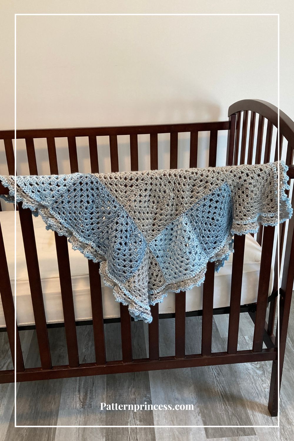 Blue and Grey Baby blanket on crib