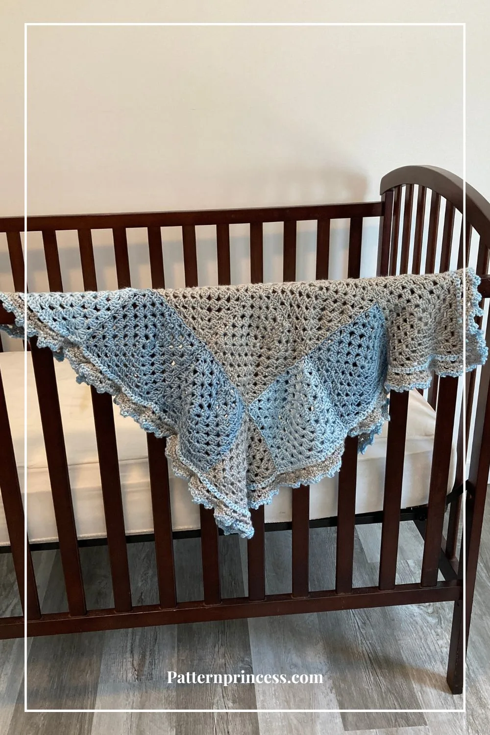 Blue and Grey Baby blanket on crib
