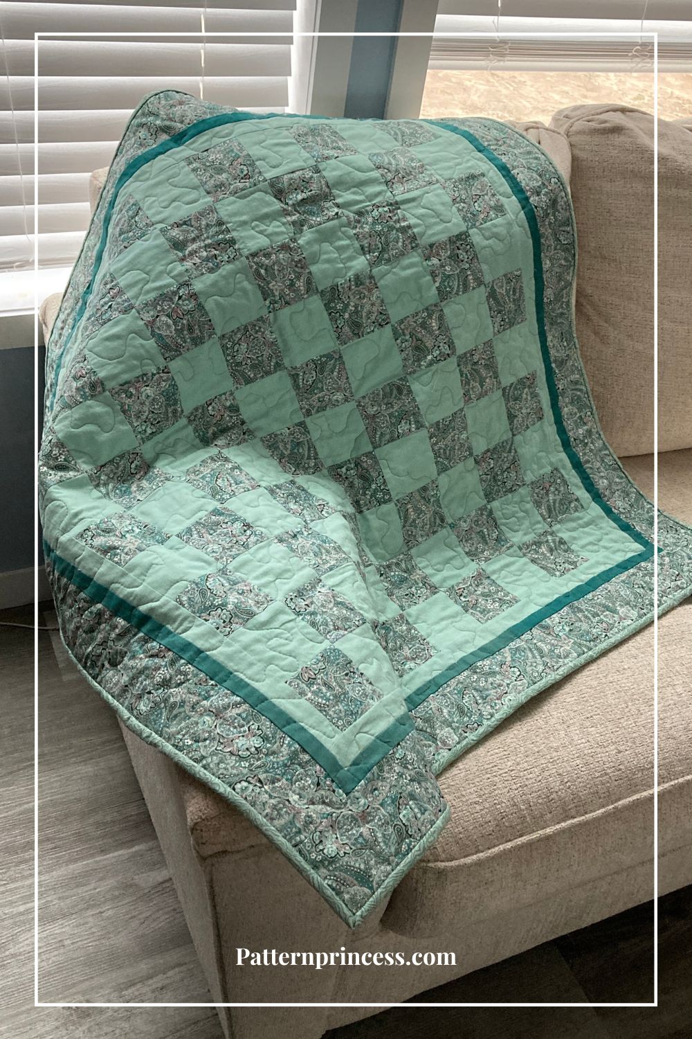 free baby quilt displayed on sofa