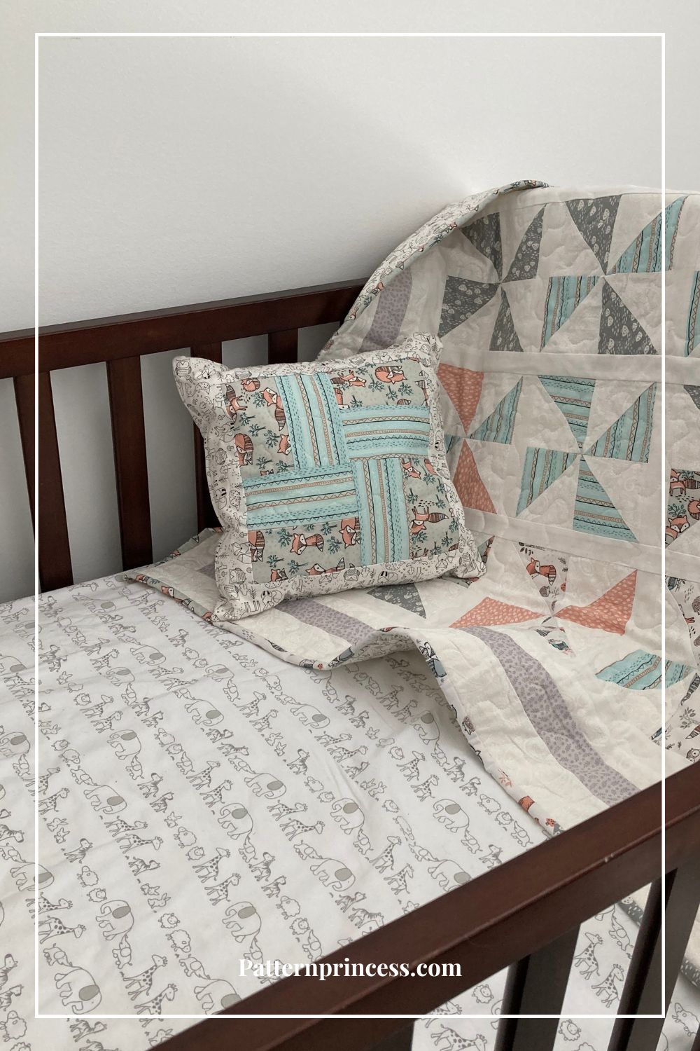 baby quilt paired with quilted pillow in baby crib